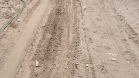 BREEZY POINT, QUEENS, NY-December 2, 2012: Sand covers road between homes after Hurricane Sandy. Video tilts up to reveal sand covered road and parked vehicle.