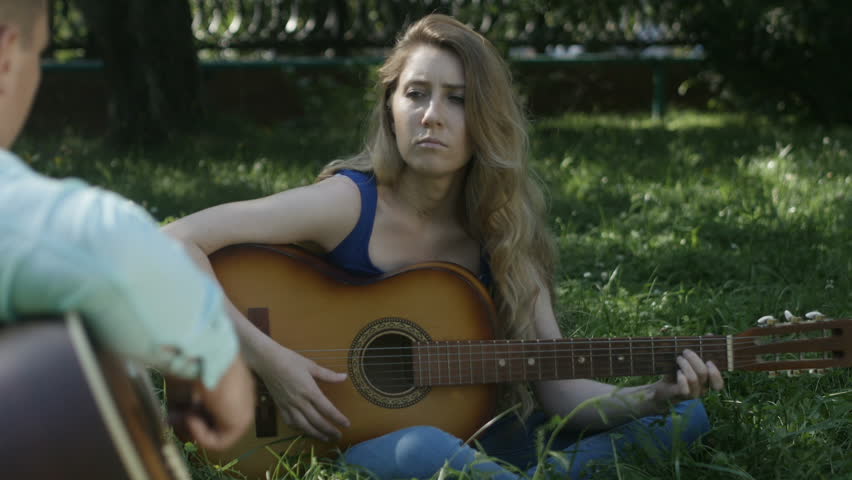 Girl pensively plays the guitar