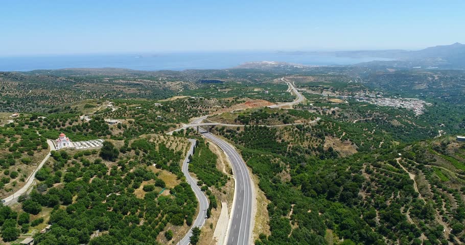 Nice view of olive tree plantations, road and houses from a bird's eye view.