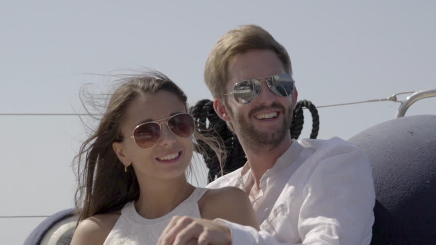 slow motion young couple with sunglasses on sailing boat man pointing at something both wow Royalty-Free Stock Footage #31517545