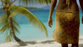 woman walking with sarong on tropical beach in the Caribbean, with audio 
