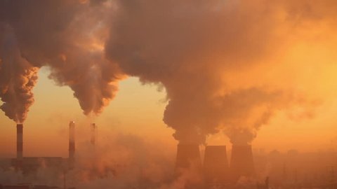 Polluting factory at dawn, time-lapse