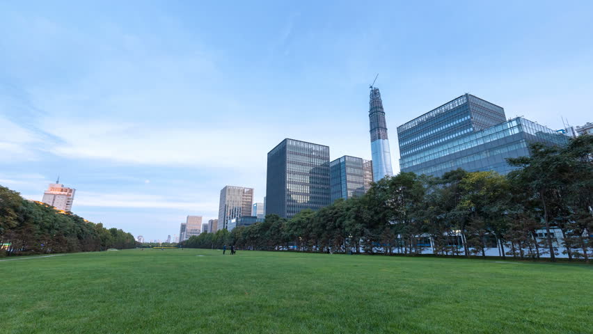 time lapse of green space and modern buildings in nightfall on tianjin binhai new district, China