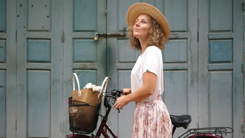Young Hipster Woman With Bicycle Smiling Outdoors Against Retro Wooden Wall. 
