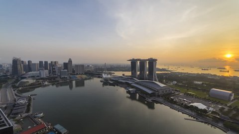 Beautiful Aerial Time lapse of Day to Night of Singapore skyline with reflection. 4K UHD.