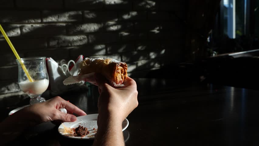 Hungry, funny woman eating tasty dessert in cafe. 4k, slow motion