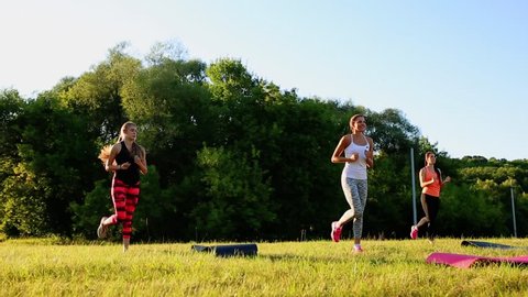 group of young people having kick boxing training , outdoor