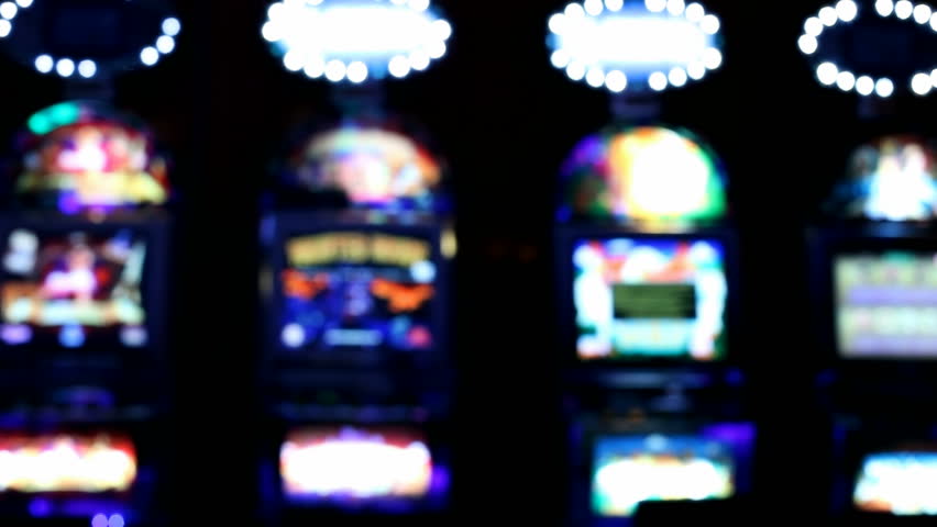Slot machines videopoker front view - A slot machine - video poker room, with lights glowing in the dark. | Shutterstock HD Video #3154018