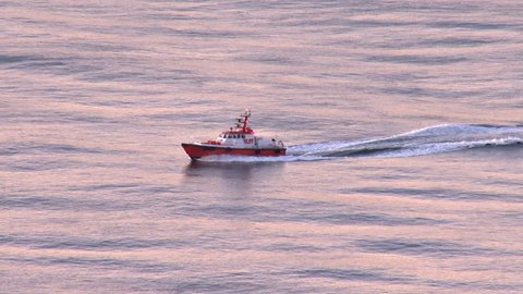 SAN FRANCISCO, CA - CIRCA 2012: Harbormaster's Pilot Boat making its way over pink-hued swells in the early morning on San Francisco Bay.