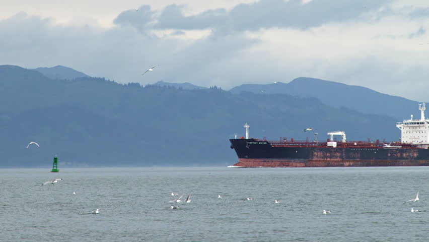 HOMER, AK - CIRCA 2012: Large, old and beaten-looking oil tanker cruising into