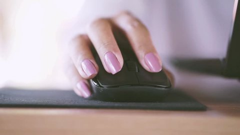 beautiful woman hand using wireless mouse computer laptop at her office 
