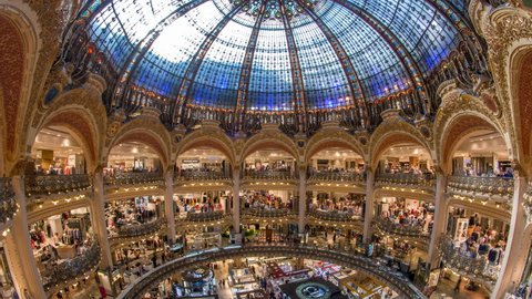 PARIS, FRANCE - CIRCA JULY 2017: Galeries Lafayette interior from top timelapse in Paris. People do shoping at department store. The architect Georges Chedanne designed the store where a Art Nouveau 