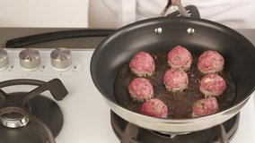 Meat balls being fried on all sides