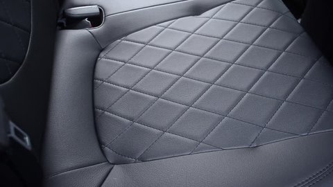 Front seats in car are made of black leather.