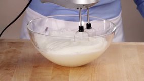 Egg whites being beaten with a hand mixer