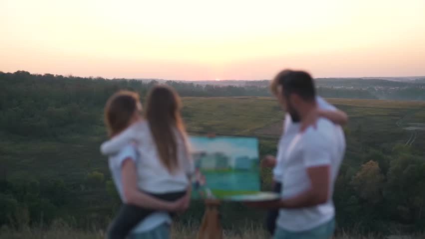 Happy family draw picture at sunset.