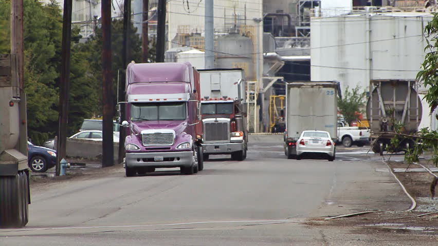 TACOMA, WA - CIRCA 2012:Trucks hauling materials and goods out of and through a