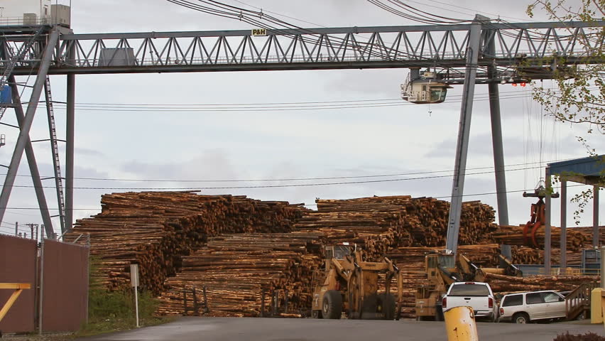 TACOMA, WA - CIRCA 2012:Gantry Crane Grapple Loader and Logging Truck