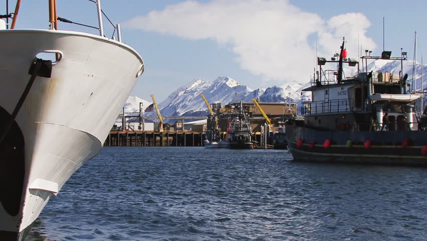 HOMER, AK - CIRCA 2012: The bow of a Coast Guard cutter in the left foreground,