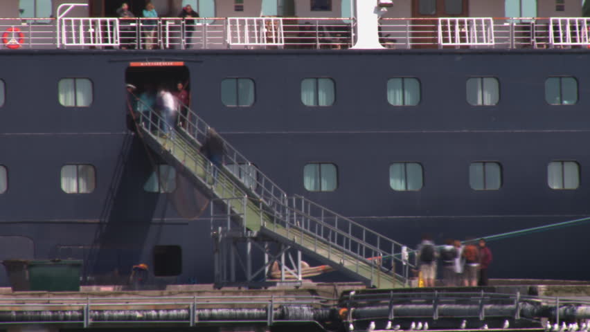 HOMER, AK - CIRCA 2011: Passengers re-boarding a cruise ship.