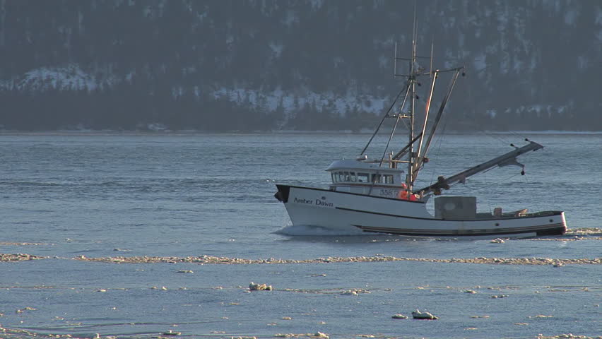 HOMER, AK - CIRCA 2012: Slanting sunlight illuminates an Alaskan fishing trawler
