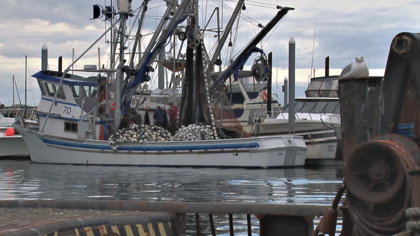 HOMER, AK - CIRCA 2011: Tending nets on a fishing boat in the harbor before