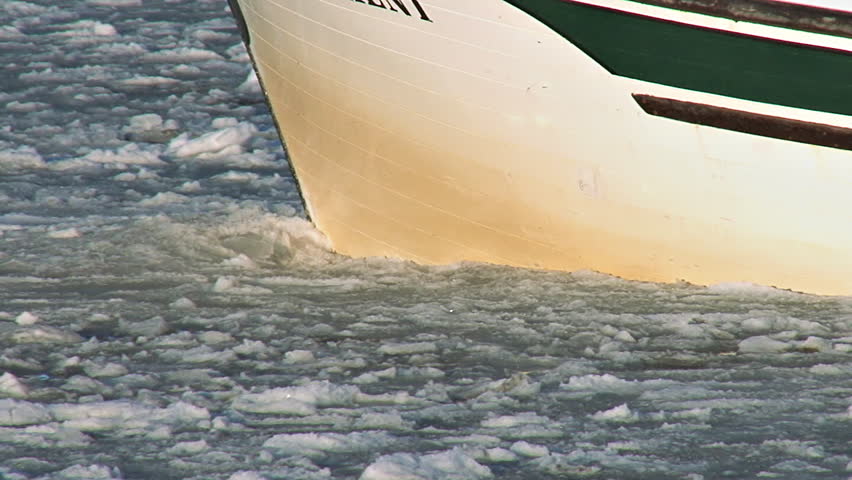 HOMER, AK - CIRCA 2012: Tracking close-up of the hull of a fishing boat cutting