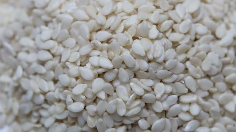  Sesame seeds (Sesamum indicum) rotating on white background. Close up
