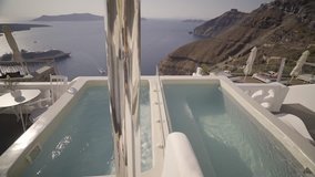 4k travel video dolly move whirlpools on terrace of luxury hotel on volcanic island of santorini