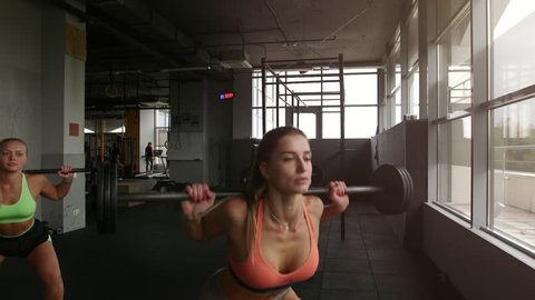 Beautiful sexy girls working out in modern gym club as part healthy lifestyle.