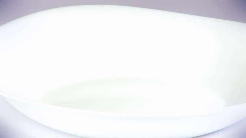 Pouring cereals, dried apricots, raisins and milk into a bowl, HD