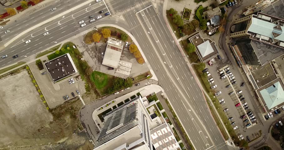 Drone flight over a growing city with new condominiums under construction.