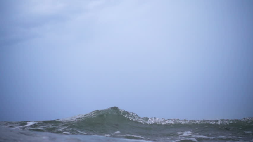 Waves on the ocean. The camera goes under water. Video recorded in slow motion.  Royalty-Free Stock Footage #31583917