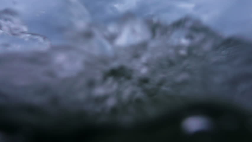Waves on the ocean. The camera goes under water. Video recorded in slow motion.  Royalty-Free Stock Footage #31583935