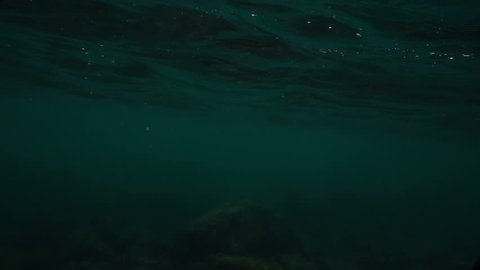 Waves on the ocean. The camera goes under water. Video recorded in slow motion. 