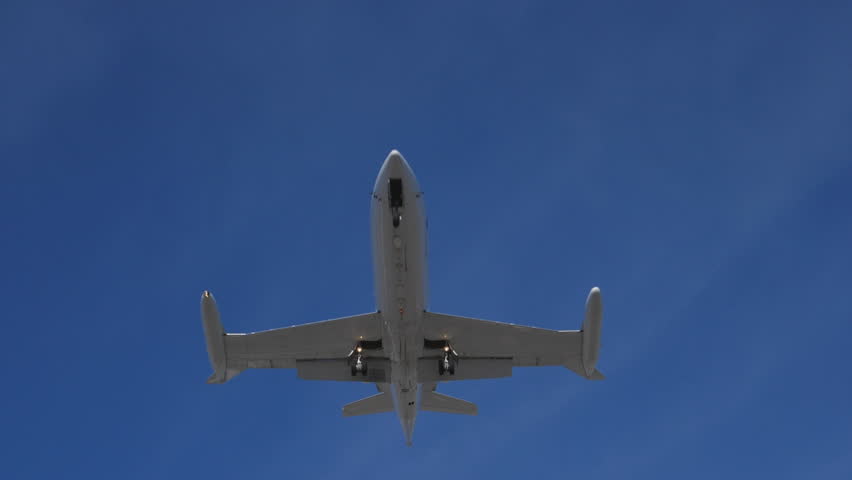 Slow motion. Private jet flies overhead. Final approach at Pearson, Toronto. No visible logos.
 | Shutterstock HD Video #31589803
