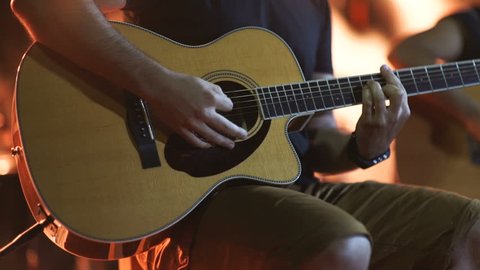 man playing guitar close up. Acoustic, classic, wooden guitar. Musician plays 