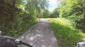 Riding bike in woods pov action film clip. Adventure and sports in nature.