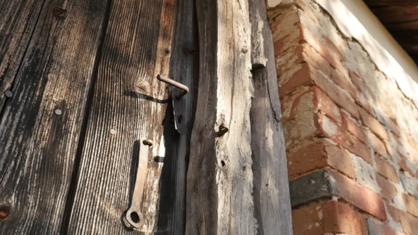 Tilting on rotten wooden planks and rusty lock details 4K 2160p 30fps UlraHD footage - Abandoned house doors  close-up slow tilt 3840X2160 UHD video