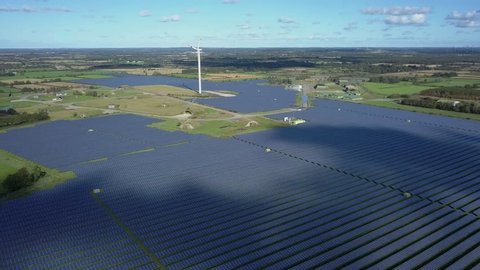 Aerial view of solar collectors solar system solar park in summer on green meadow, Eggebek Germany – 4K