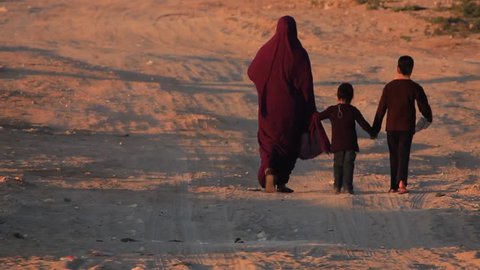Arab muslim women in Burka/Hijab walking with kids 