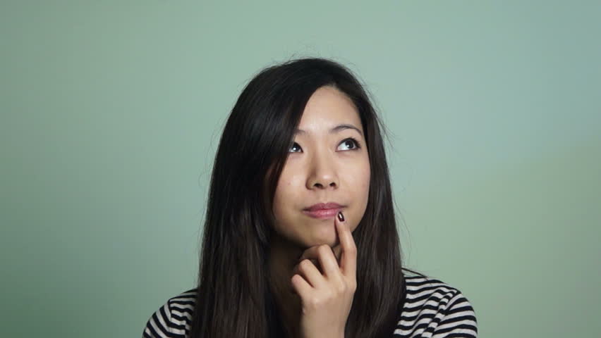 Asian woman thinking at something