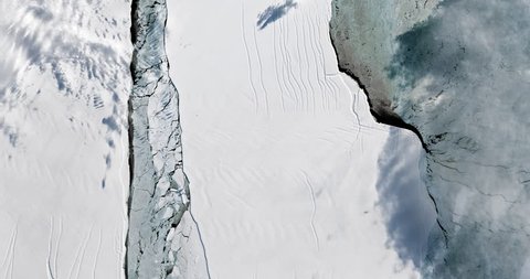 Very high-altitude overflight aerial of iceberg A-68 calving on the Larsen ice shelf, Antarctica. Clip loops and is reversible. Elements of this image furnished by NASA