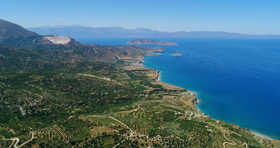 View of the plantation of olive trees and the Aegean Sea from a bird's eye view close-up.