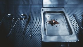 the surgeon throws the bullet on the tray after surgery