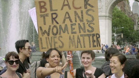 NEW YORK JUNE 24, 2017: Black Trans Women Lives Matter Transgender Rights Sign Washington Square Park NYC. A demonstration for LGBT rights filled the public park on the hot summer day.