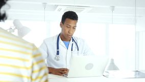 Afro-American Doctor Talking with Patient, Discussing about Health Care