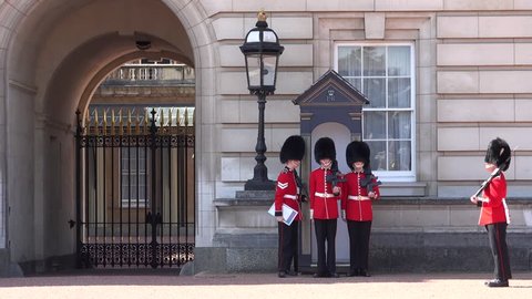 LONDON, ENGLAND, UK - AUGUST 13, 2017: Change of guards at Buckingham Palace. Infantry sentries of Queen's Guard respect a strict protocol when switching the shifts