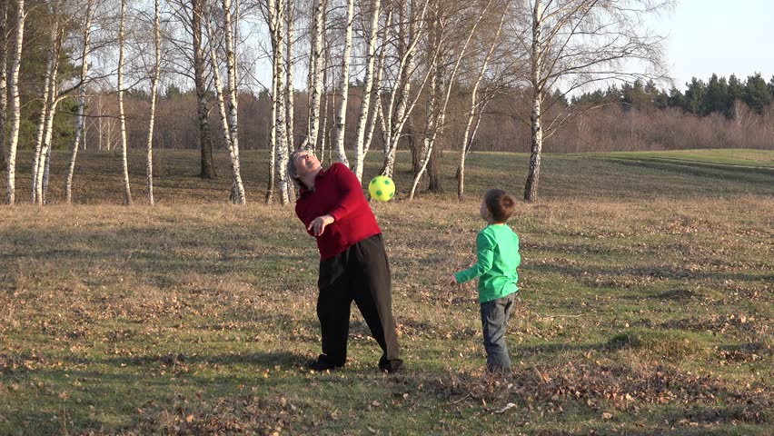 Grandmother showing tricks with foot ball to grandson, grandparent play outdoor with grandchild | Shutterstock HD Video #31639990