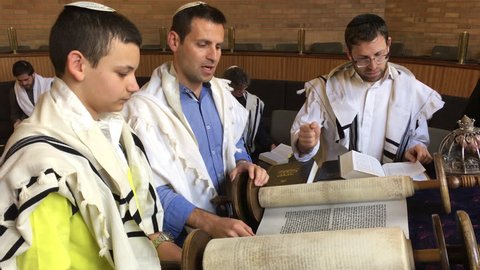 AUCKLAND - OCT 11 2017:Jewish people reading from the Torah Aliyah Blessings during the High Holidays. Reading the Torah is one of the bases for Jewish life. 